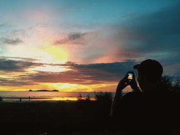 Silhouette of man standing on beach