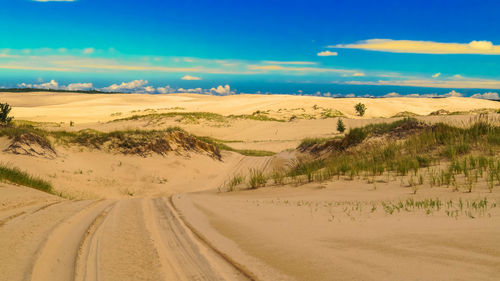 Scenic view of desert against blue sky