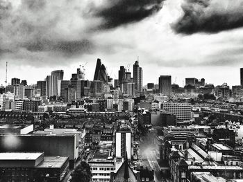View of cityscape against cloudy sky