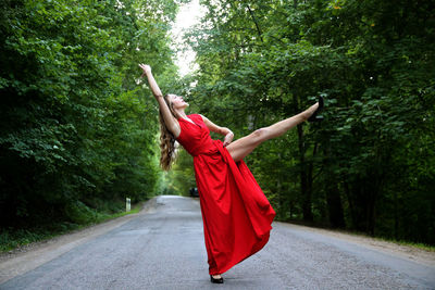 Rear view of woman standing on road