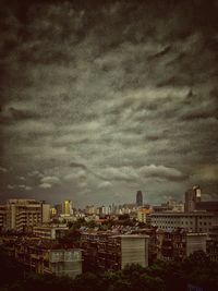 Buildings against cloudy sky