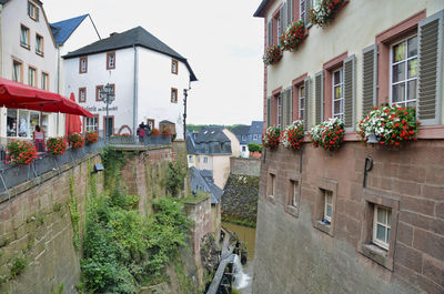 People on street amidst buildings in city