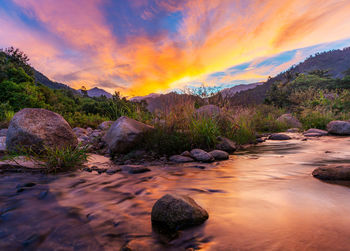 Scenic view of rocks against sky during sunset