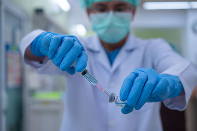 Midsection of man holding umbrella