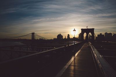 Brooklyn bridge against sky during sunset in city