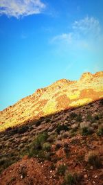 Low angle view of mountain against blue sky