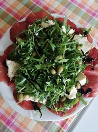 High angle view of chopped fruits in plate on table