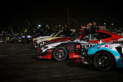 Cars parked on road at night