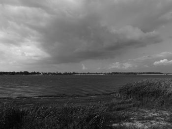 View of calm sea against cloudy sky