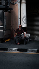 Man sitting in shopping cart