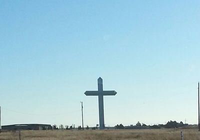 Cross against clear blue sky