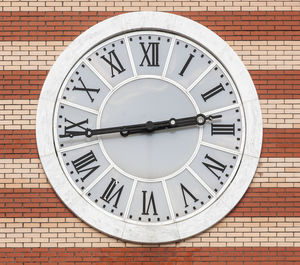 Clock on brick wall background