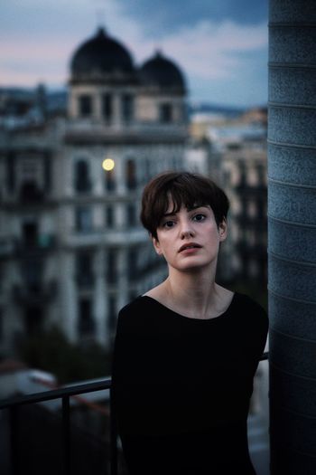 Portrait of woman standing on building terrace