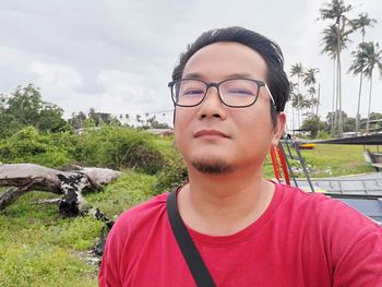 Portrait of young man against sky