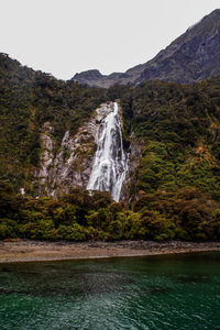 Scenic view of waterfall against clear sky