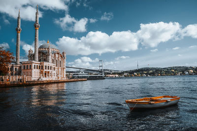 View of boats in river against cloudy sky. istanbul ortaköy turkey 