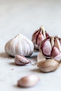 Close-up of garlic on table against white background