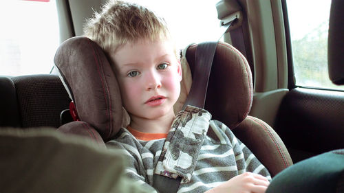 Portrait of boy sitting in car