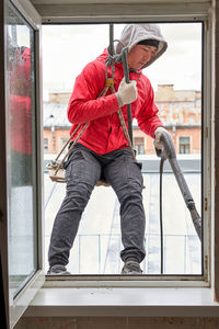 Man working on glass window