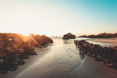 Scenic view of sea against clear sky during sunset
