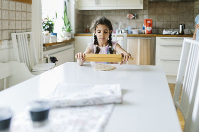 Girl rolling dough