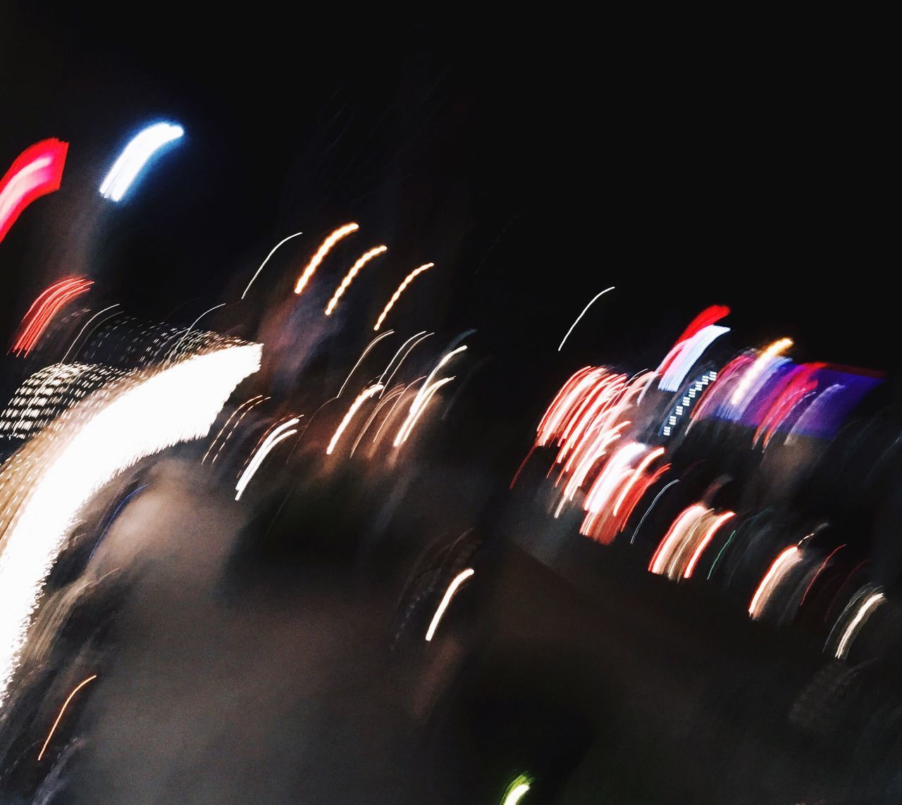 LOW ANGLE VIEW OF ILLUMINATED FIREWORKS AT NIGHT