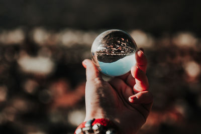 Midsection of woman holding crystal ball