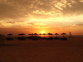 Scenic view of beach against sky during sunset