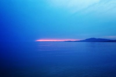 Scenic view of sea against clear sky at sunset