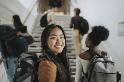 Portrait of smiling female student at university