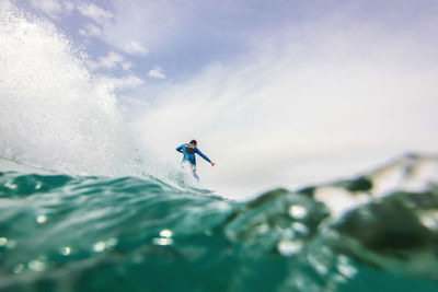 Man in sea against sky