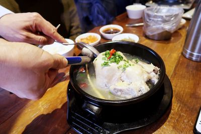 Midsection of person preparing food in restaurant