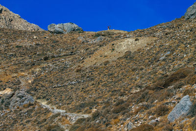 Low angle view of mountain against blue sky