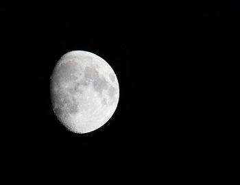 Low angle view of moon against clear sky at night