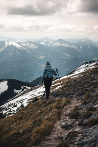 Rear view of man standing on mountain