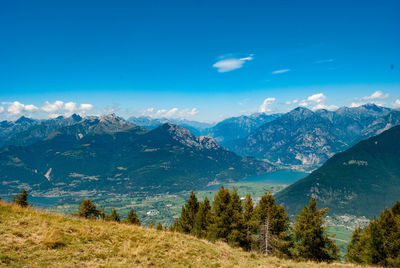 Scenic view of mountains against blue sky