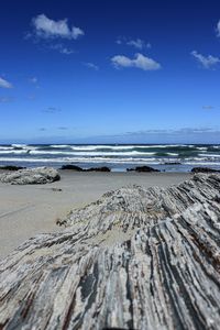 Scenic view of beach against blue sky