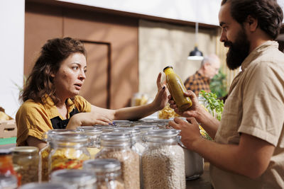 Portrait of smiling friends having food at home