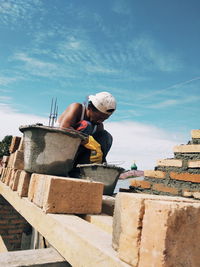 Low angle view of man working at construction site