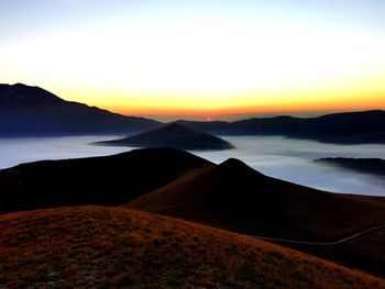 Scenic view of silhouette mountains against sky during sunset