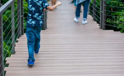 Low section of people walking on footpath