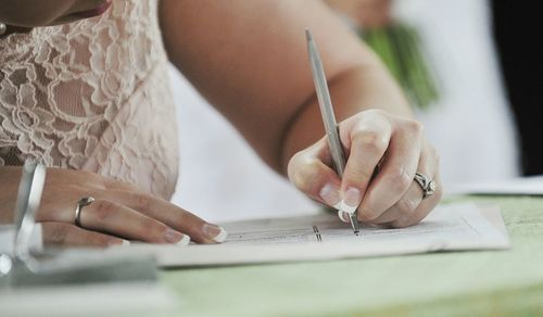 Woman signing on wedding ceremony