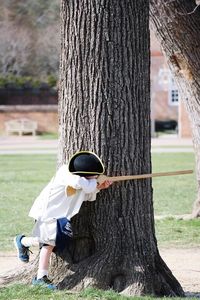 Man standing on tree trunk