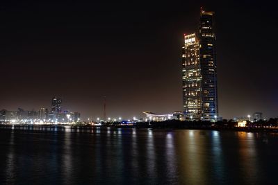 Illuminated city buildings at waterfront