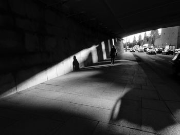 Shadow of people on street in city