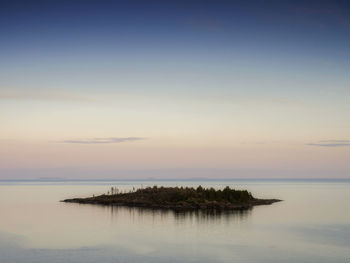 Scenic view of sea against sky at sunset