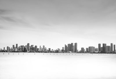 Panoramic view of sea and buildings against sky