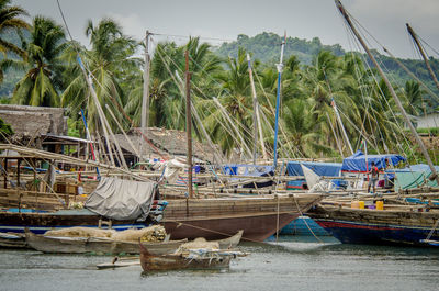 View of fishing boats moored at shore against sky