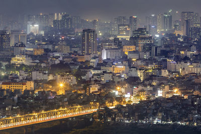 High angle view of illuminated city buildings at night