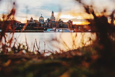 View of city at waterfront during sunset